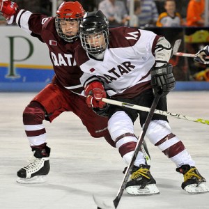 Hockey players in Qatar battle for a puck. (Courtesy: Qatar Winter Olympics Committee)